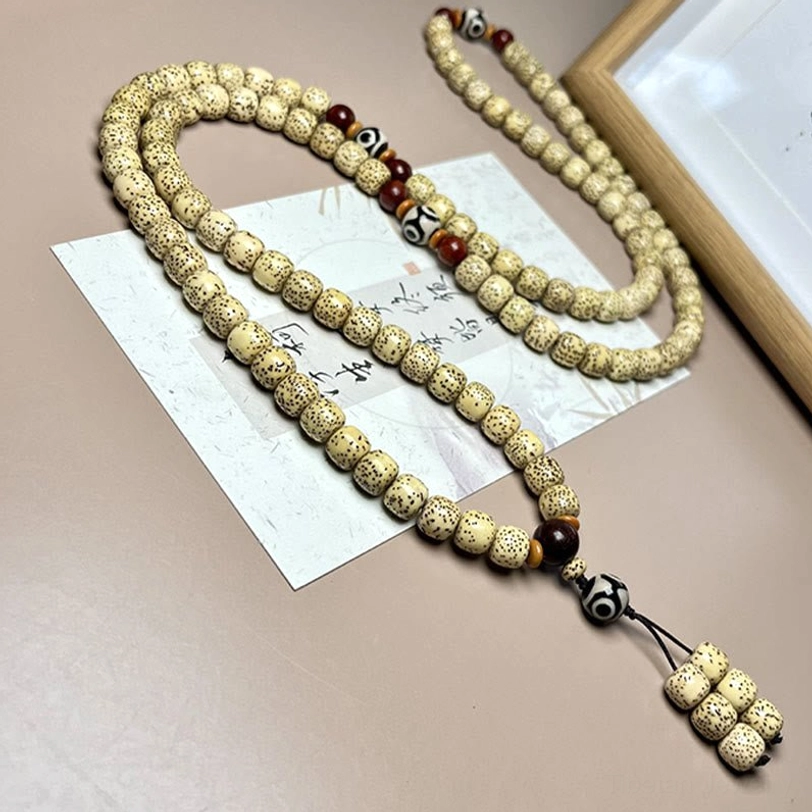 Long 108 mala bead necklace with Bodhi seeds and Dzi bead looped multiple times showing versatile wearing style