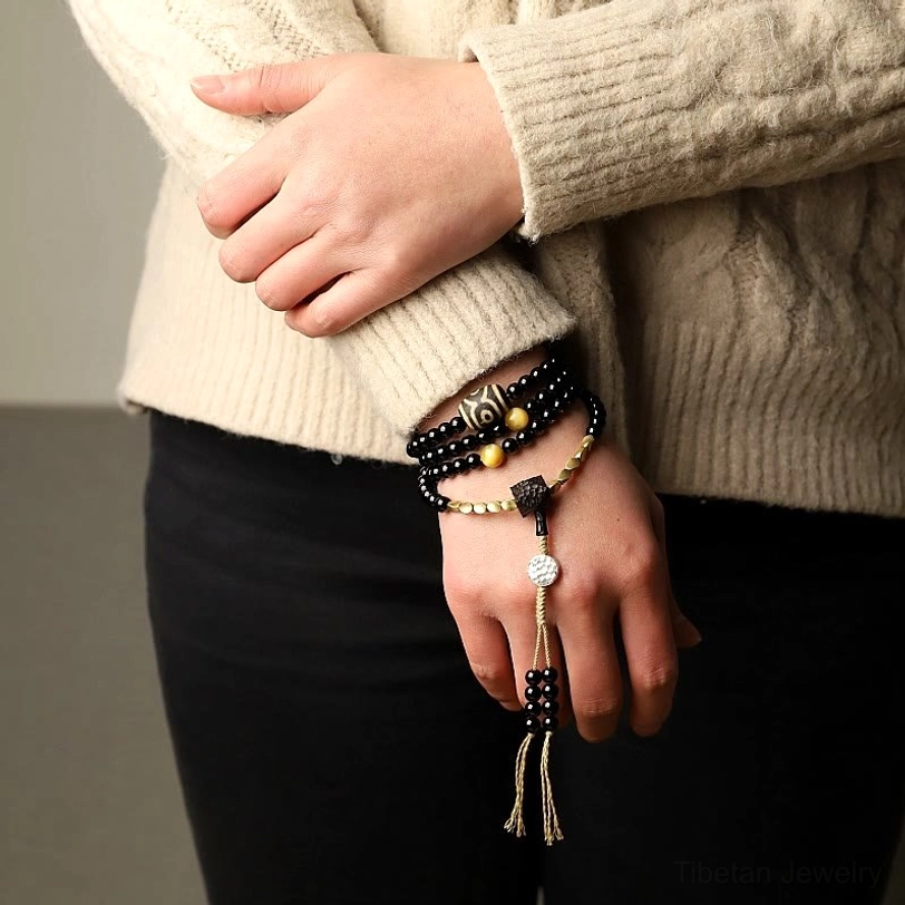 Protective mala bracelet with three-eyed dzi bead and black onyx for spiritual seekers