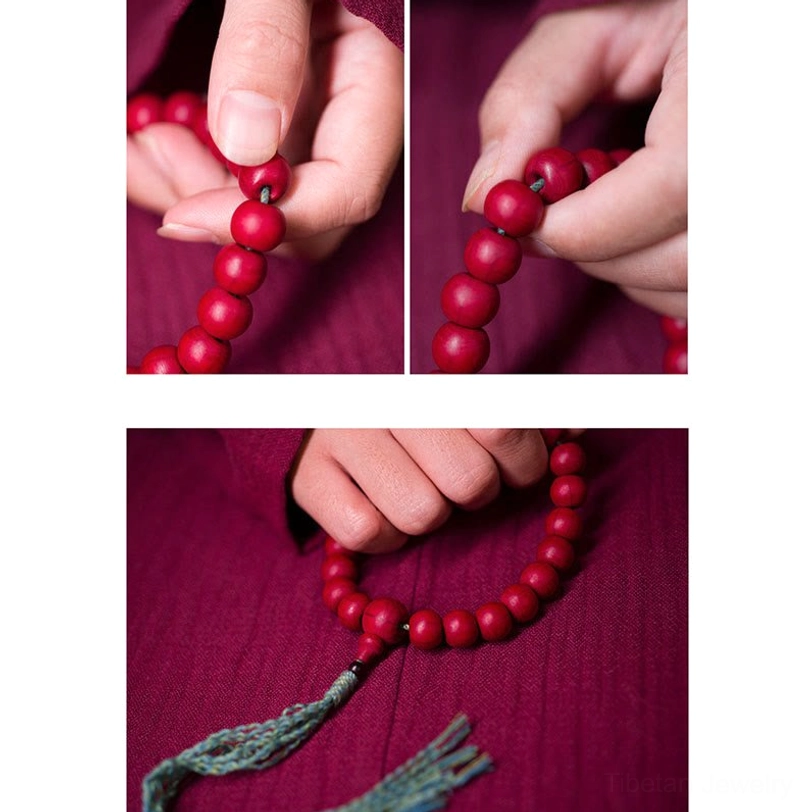Hand-held circular tibetan dragon wood wrist mala with teal tassel overhead view