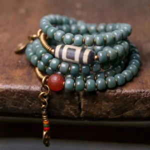 Coiled Tibetan Mala Bracelet with Striped Dzi Bead and Red Agate Close-Up Detail