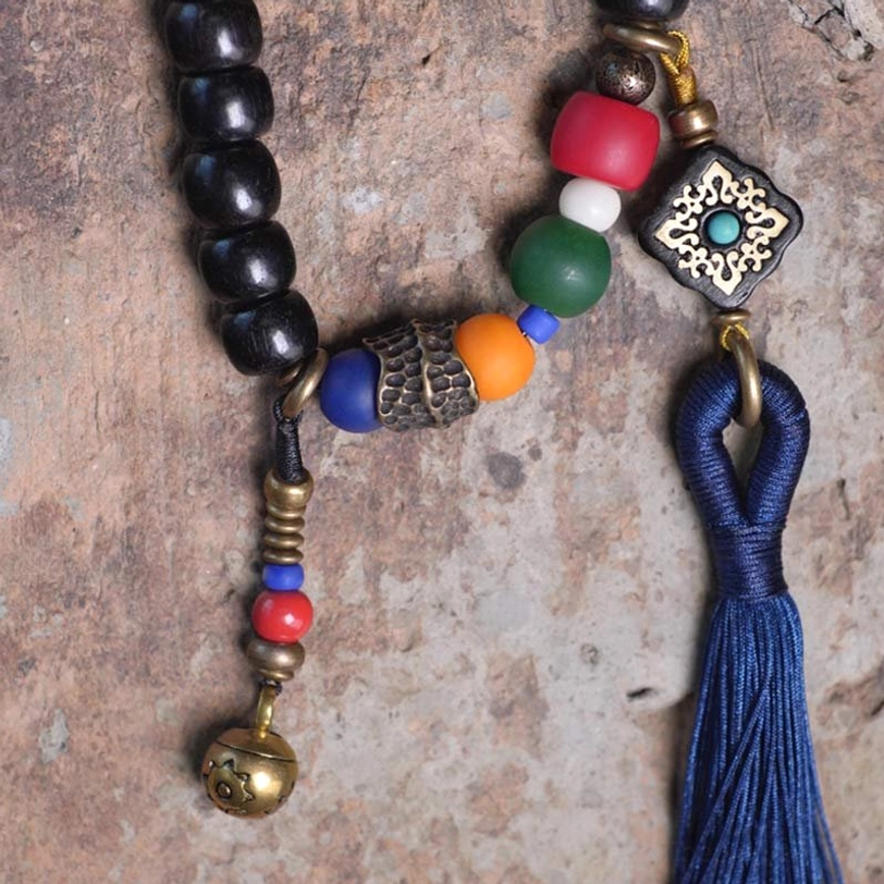 Tibetan 108-bead mala bracelet with ebony wood dzi bead and copper accents - product packaging and presentation