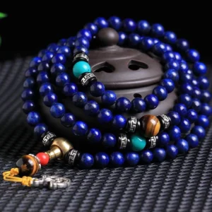 Tibetan prayer mala bracelet featuring lapis lazuli, tiger eye and turquoise beads with silver spacers detailed close-up