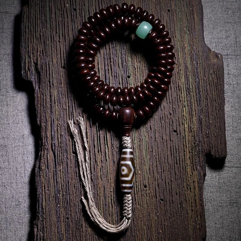 Complete Tibetan mala bracelet with purple bodhi seeds, three-eyed dzi bead, and hemp tassel