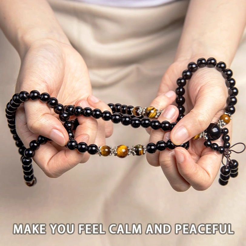 Handmade 108 bead mala bracelet worn on hands with light fabric background, showing wearable styles