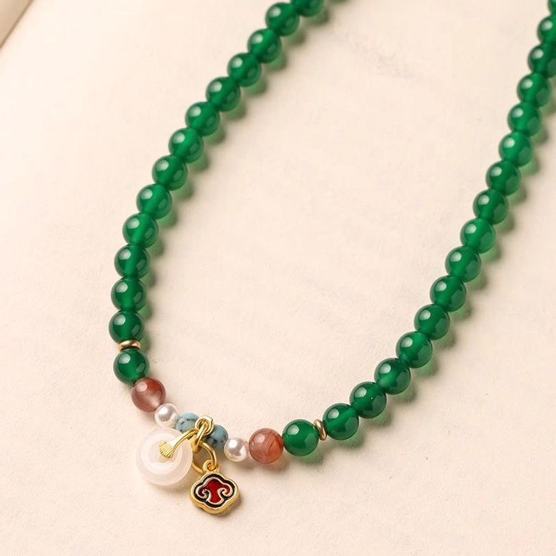 Single strand green agate Tibetan mala with gemstone end pendants and peace buckle charm detail