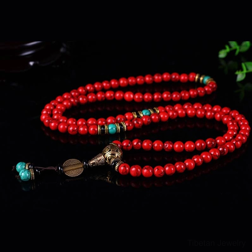 Double mala necklace bracelet set flat lay with red beads turquoise charms and bronze metal fittings