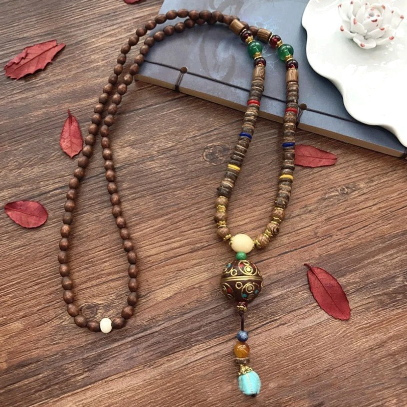 Tibetan mala necklace product showcase with wooden beads and copper accents on neutral background