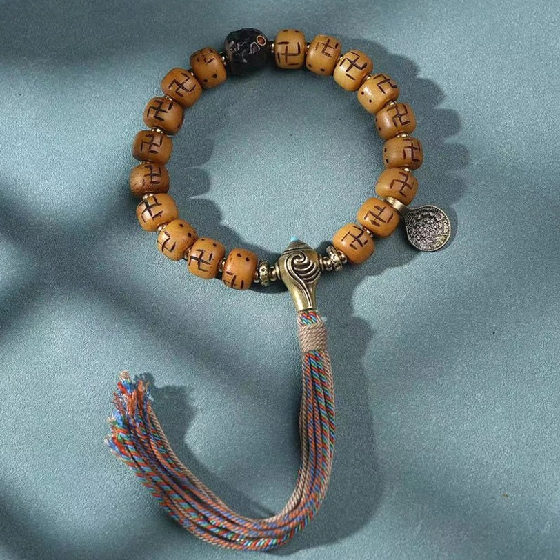 Tibetan mala prayer bracelet with camel bone barrel beads, black spacers, metal counter, and blue-brown tassel - spiritual practice jewelry