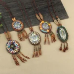 Collection of handcrafted Tibetan mandala beaded necklaces with multiple design styles displayed on natural wood backdrop