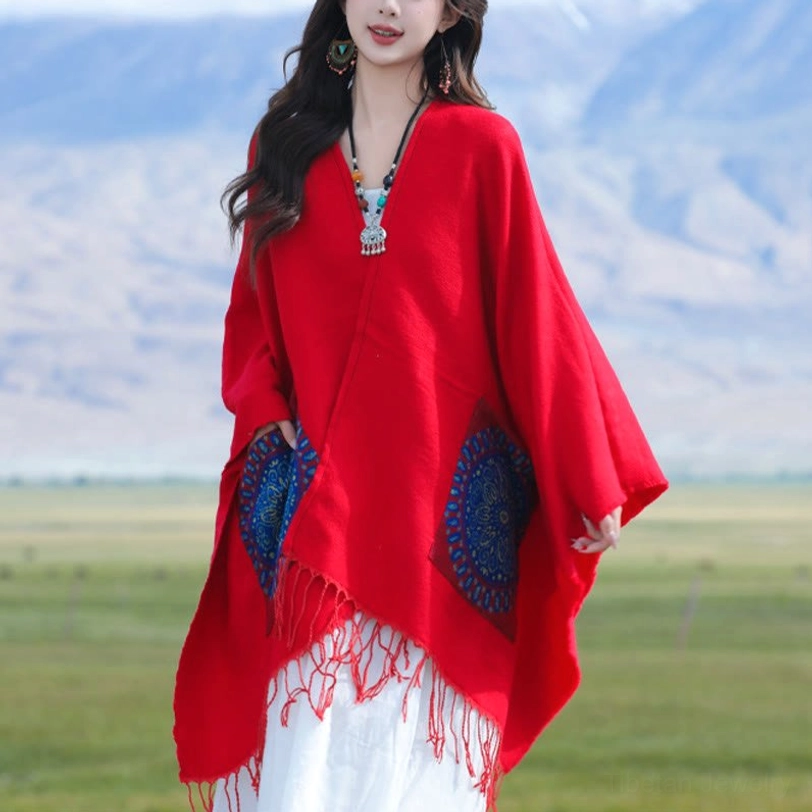 Red mandala tassel shawl worn with blue mandala patches, front side pose on grass