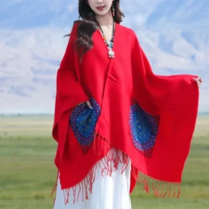 Red geometric mandala wrap with side pockets and tassel fringe, front three-quarter view