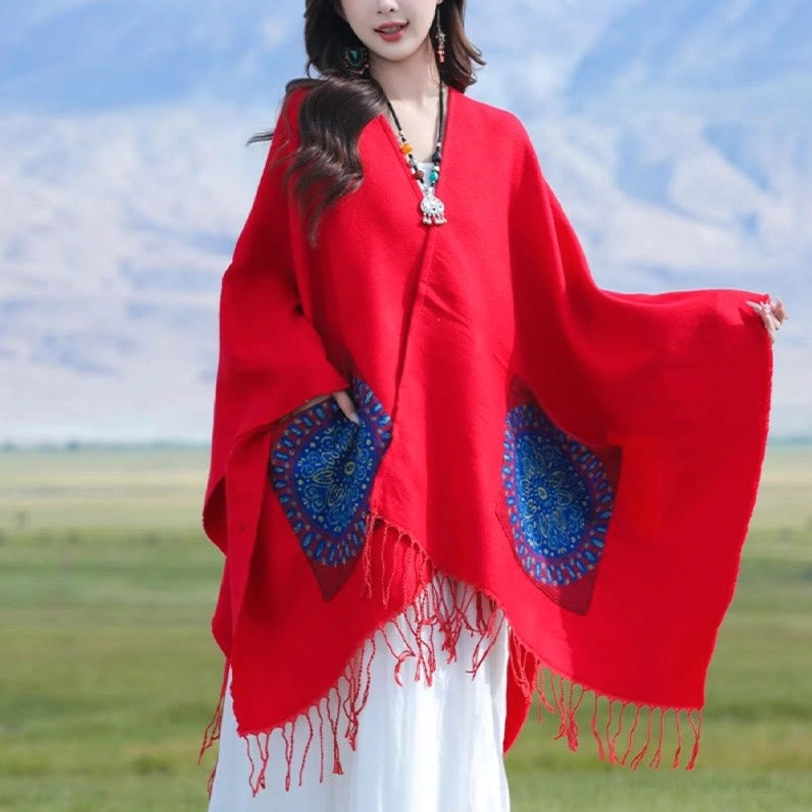 Red geometric mandala wrap with side pockets and tassel fringe, front three-quarter view