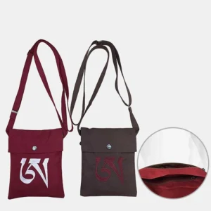 Handmade OM mantra embroidered bag showing interior zipper pocket, adjustable metal buckle strap, and snap button details