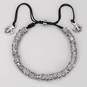 Tibetan mantra bracelet front view displaying engraved alloy silver beads with cloud-shaped charm pendant and adjustable black cord