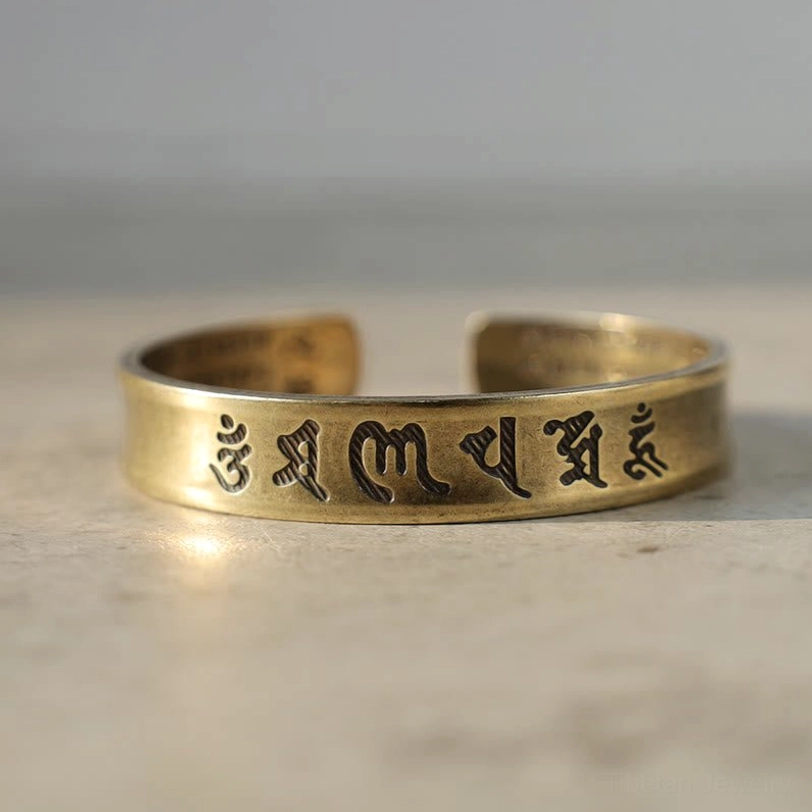 Brass Tibetan mantra cuff bracelet with bright metal reflective highlights