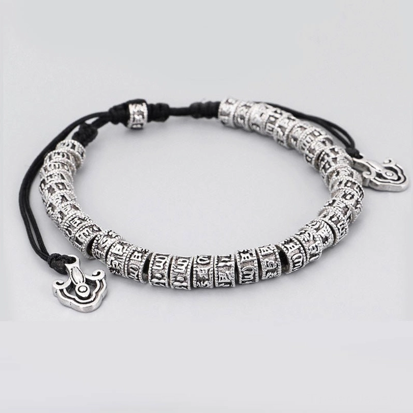 Side profile of handmade Tibetan mantra bracelet showing full bead loop with single cloud hanging charm on white background