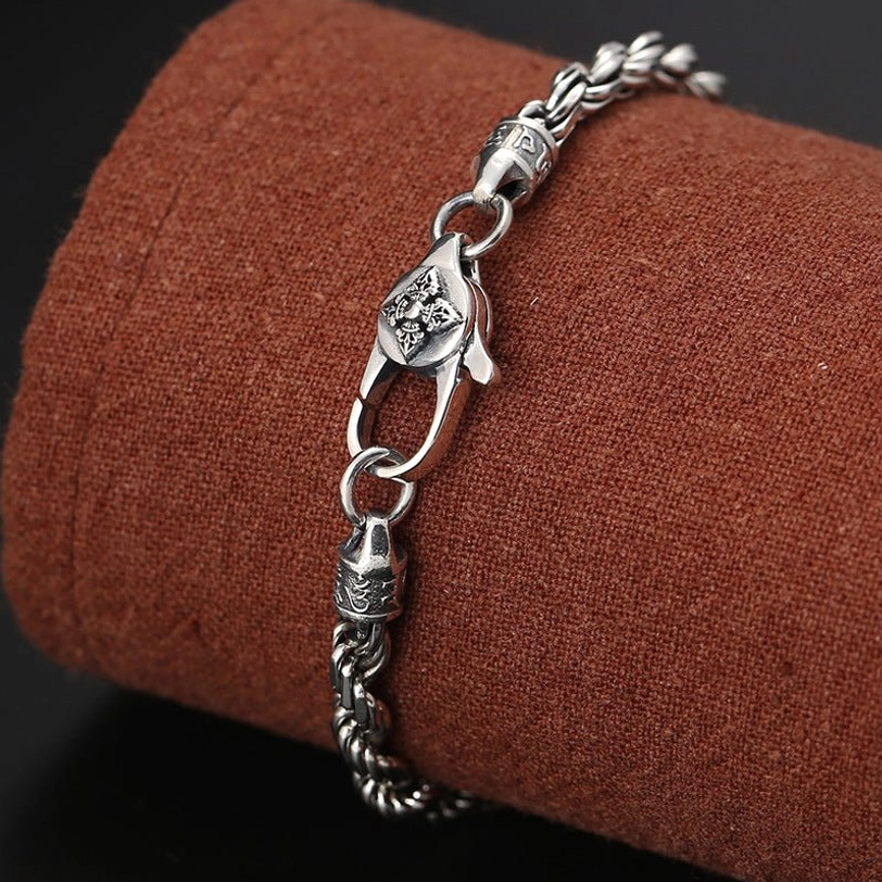 925 Sterling Silver Om Mani Padme Hum bracelet displayed on fabric stand showing full twisted rope design with carved clasp joint
