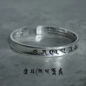 Tibetan mantra white copper bracelet top-down view showing engraved Sanskrit text and inner full mantra inscription