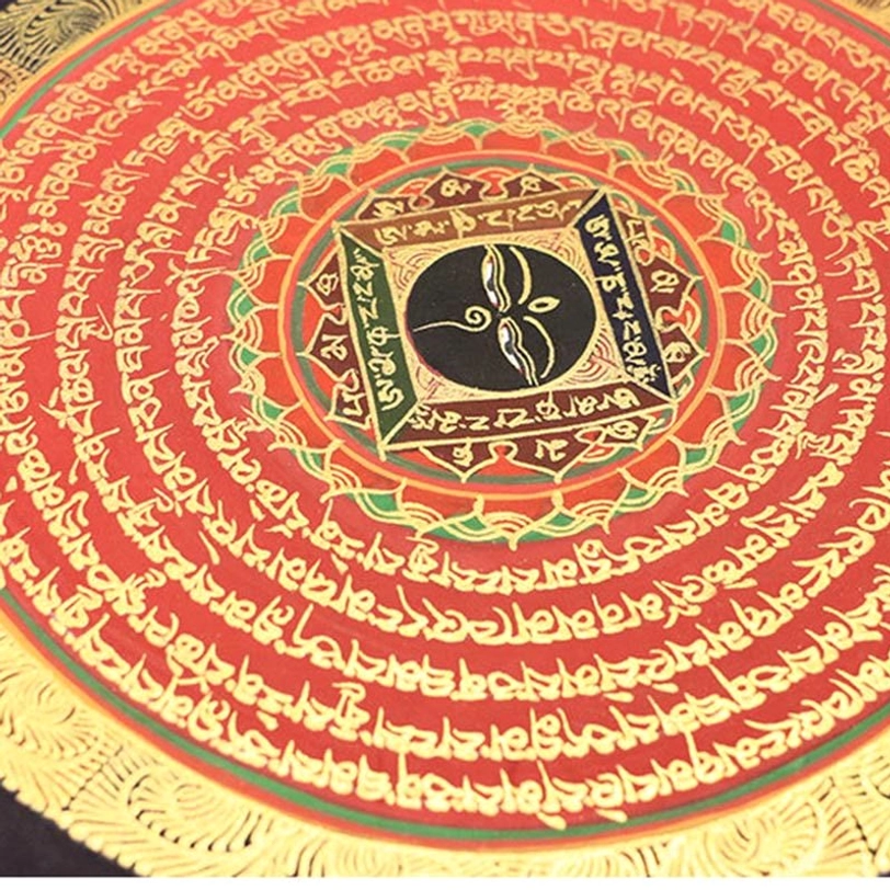 Close-up of red circular Tibetan mantra mandala thangka with central black and gold sacred pattern and green-gold border accents