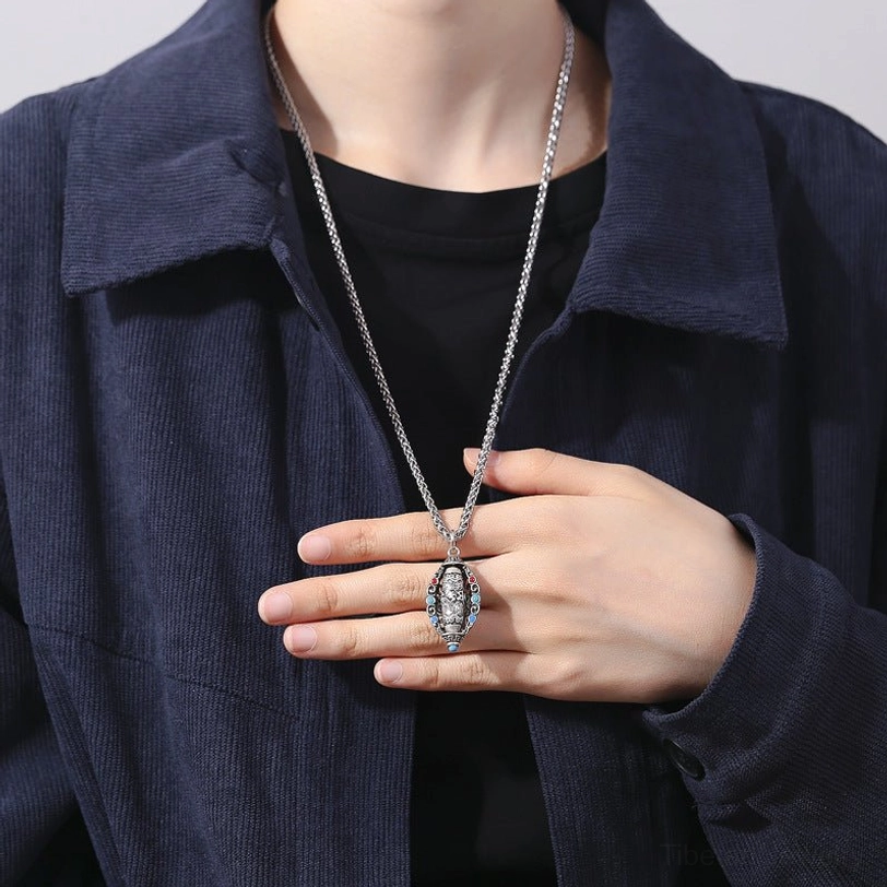 Tibetan Om necklace worn as lifestyle accessory on chest with dark shirt and jacket showing daily wear styling