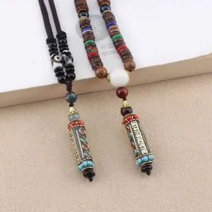 Two Tibetan Om Mani Padme Hum necklaces with white round accent beads, flat lay comparison