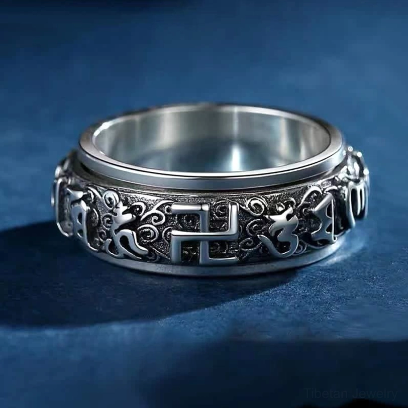 Tibetan Om Mani Padme Hum rotatable copper ring with swastika symbol, front oblique view showing vintage finish and embossed religious patterns