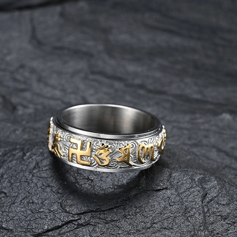 Silver titanium steel spinner ring featuring Om Mani Padme Hum mantra with swastika symbol and rotatable carved band