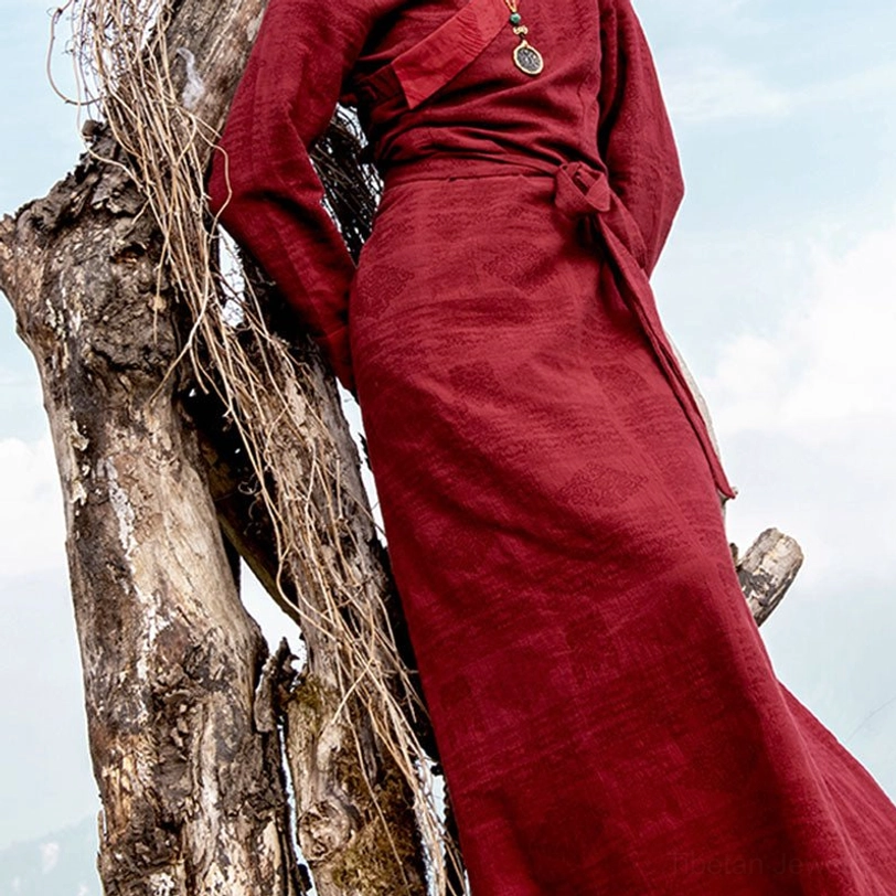 Lower body detail of Tibetan maxi dress showing tied waist sash and flowing floor-length skirt with textured handwoven fabric