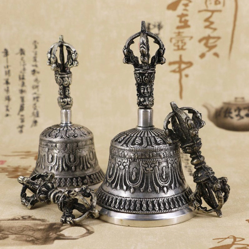 Tibetan meditation bell showing top-down view of vajra finial crown and interior bell chamber revealing handcrafted quality