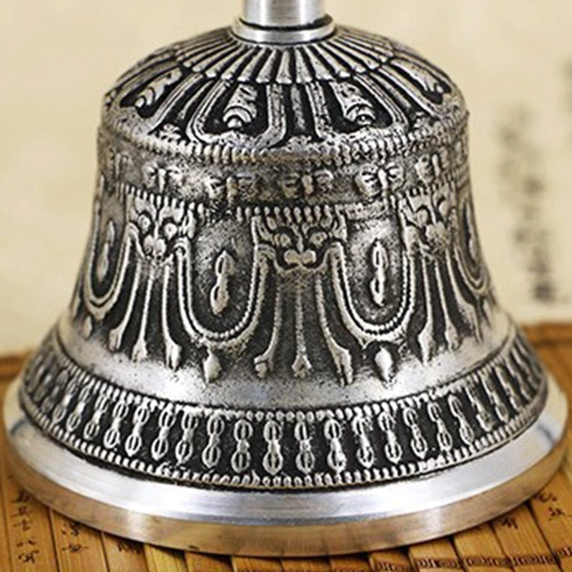 Handcrafted Tibetan meditation bell and vajra dorje copper instruments displayed together showing the sacred paired spiritual symbol