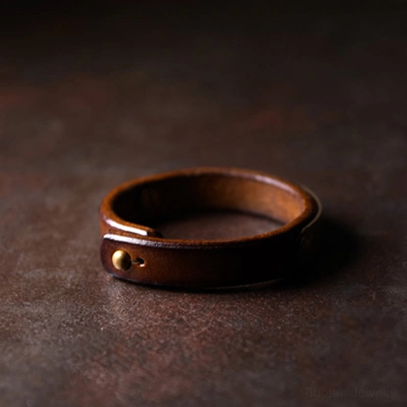Minimalist Tibetan wealth bracelet in brown leather with polished brass hardware and adjustable punch hole design