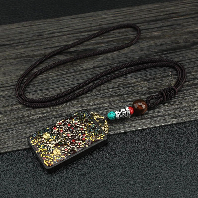Tibetan Money Tree thangka pendant necklace showing growth and abundance symbolism with gold decorative elements and beaded rope