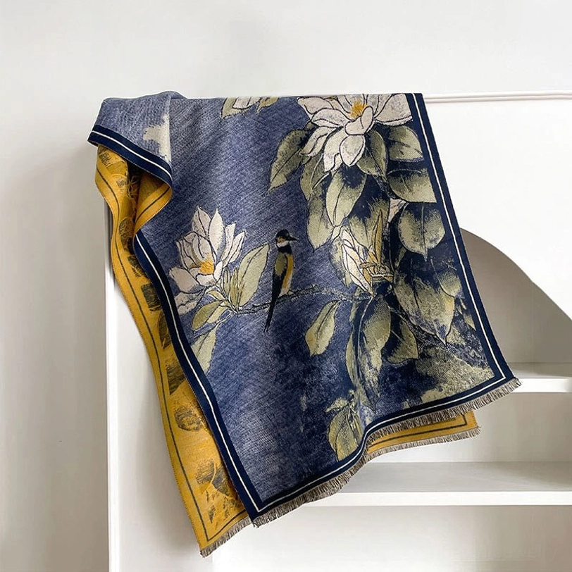 Navy blue Tibetan scarf with green magnolia flower pattern displayed on white shelf background
