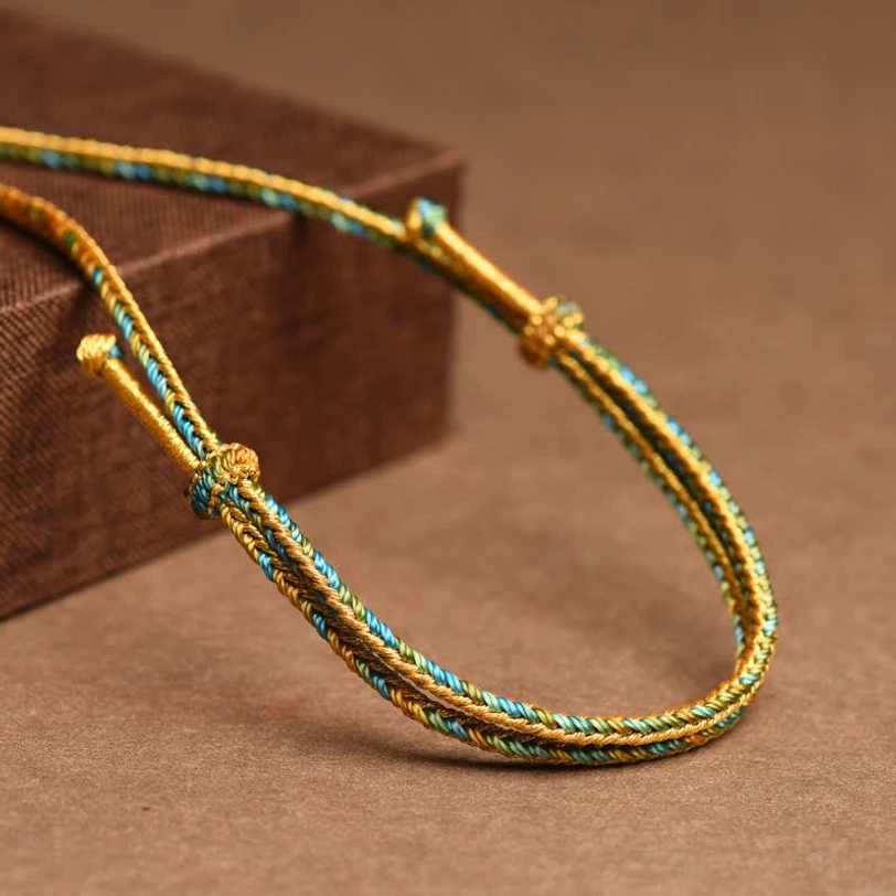 Tibetan braided copper necklace cord showing gold-teal rope with adjustable toggle clasp detailed view