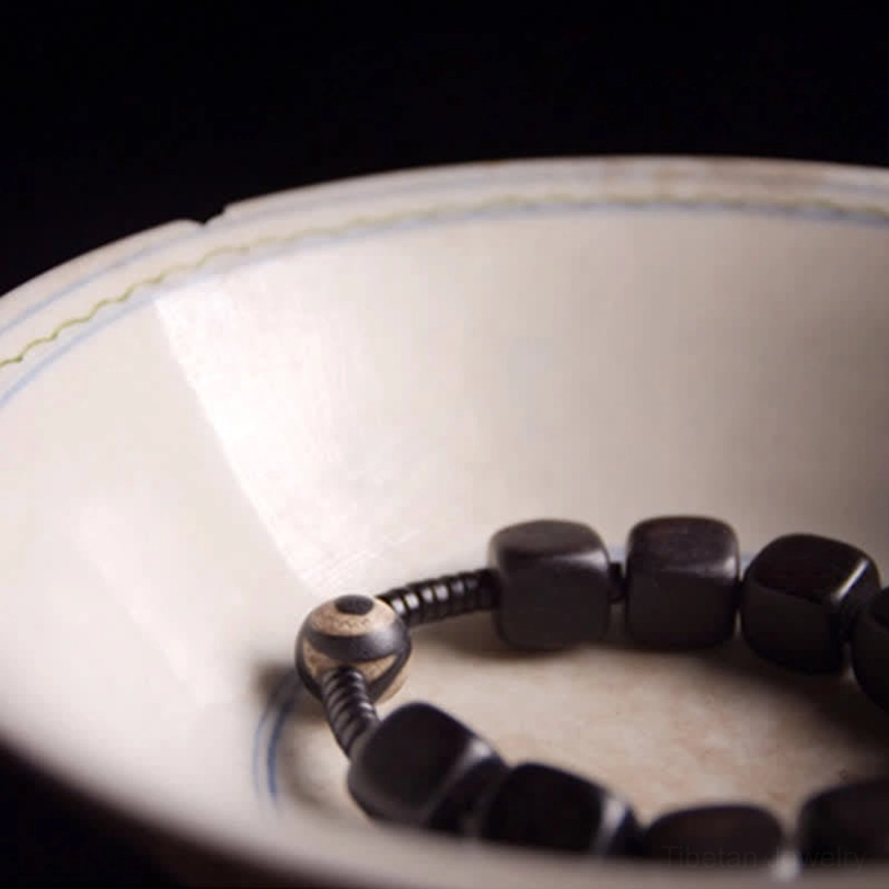 Nine-eye dzi bead bracelet authentic tibetan craftsmanship natural ebony wood sustainable materials spiritual wellness