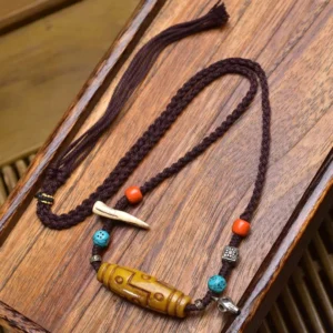 Handmade Tibetan Nine-Eye Dzi copper necklace with bone-shaped accent and orange turquoise spacer beads