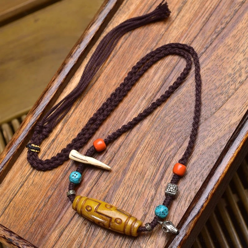 Handmade Tibetan Nine-Eye Dzi copper necklace with bone-shaped accent and orange turquoise spacer beads