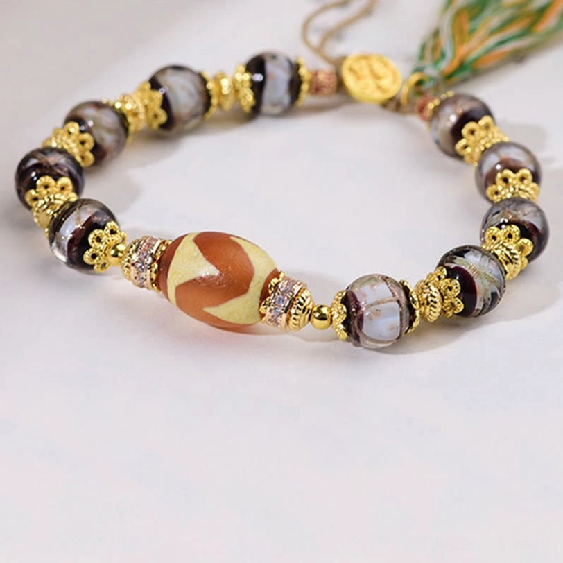 Tibetan Dzi bead bracelet featuring authentic hand-painted Nine-Eye Dzi and glass bead combination