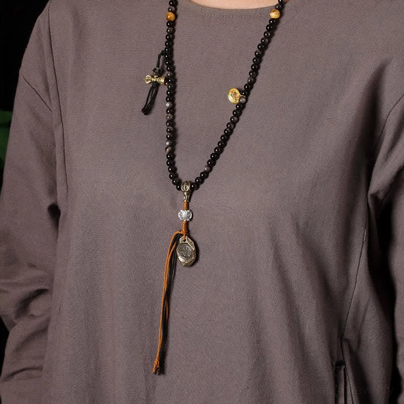 Tibetan obsidian Garuda protection necklace coiled display showing full length 18 inches