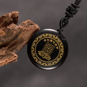 Black obsidian Buddhist necklace with braided rope and wooden prop three-quarter view