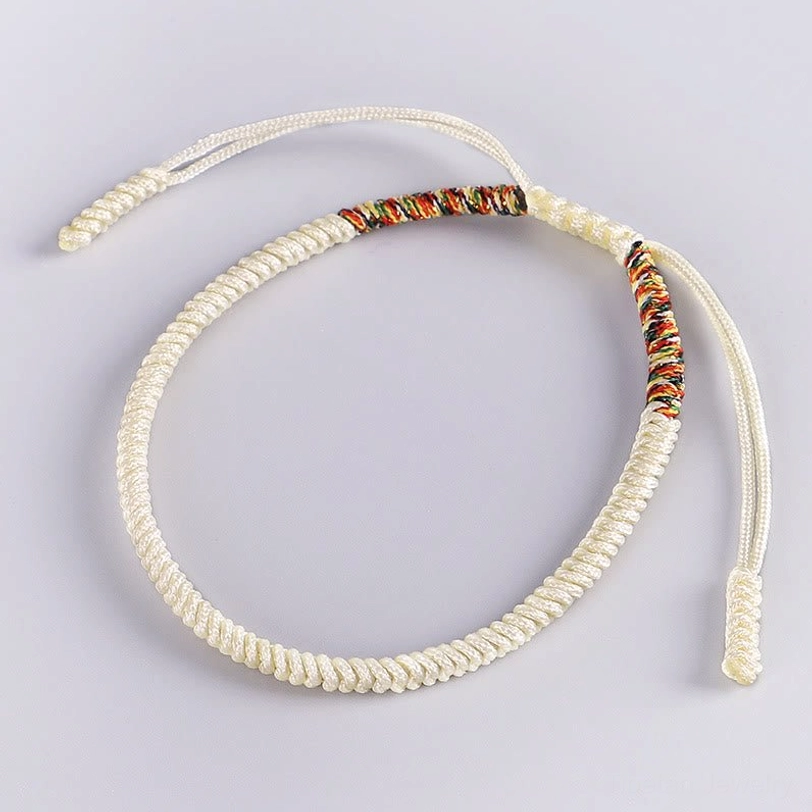 Off-white Tibetan woven bracelet with colorful decorative knot and adjustable cord ends