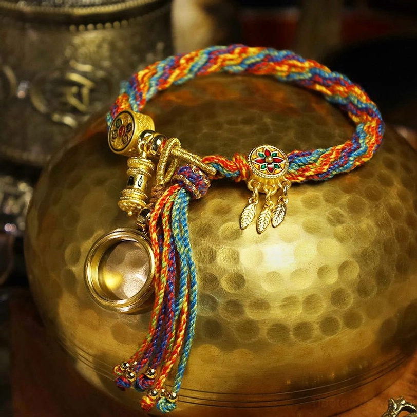 Handmade Tibetan protection bracelet featuring gold leaf dreamcatcher pendant and rainbow braided cord