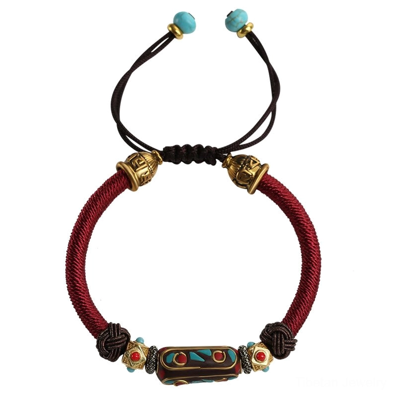 Tibetan Om Mani Padme Hum bracelet front view with adjustable pull cord, vintage enamel tube bead, and gold copper metal accents on white background