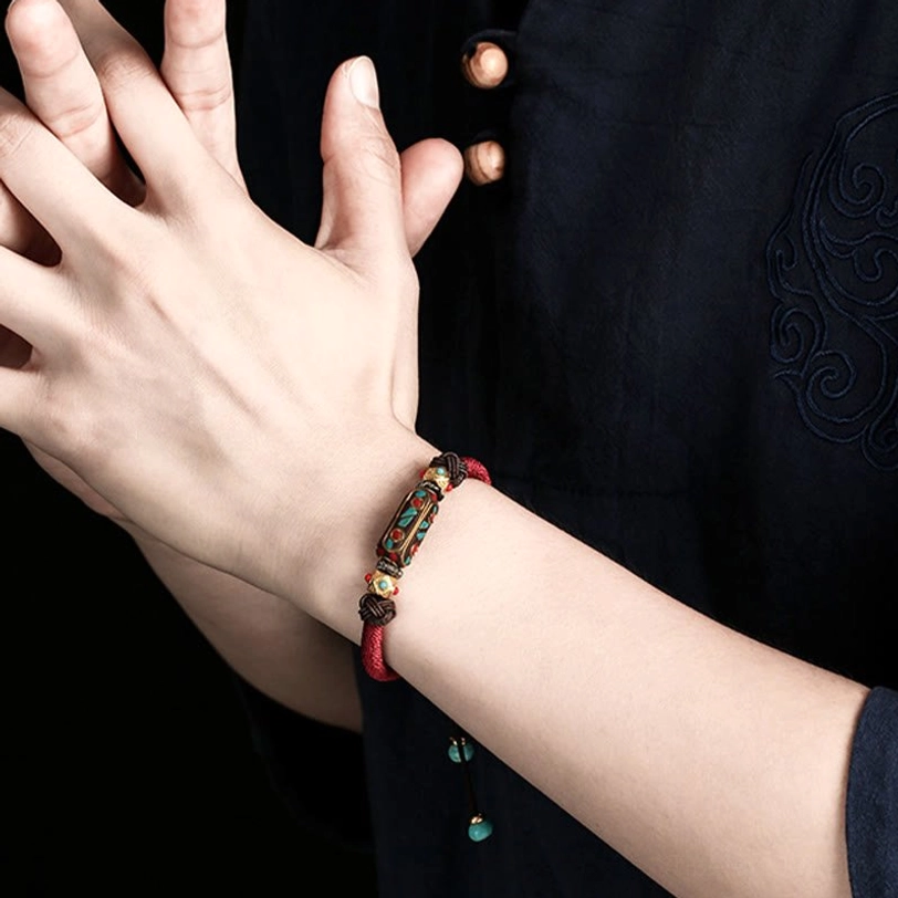 Tibetan braided bracelet worn on wrist showing real-world wearing effect and fit on traditional clothing background