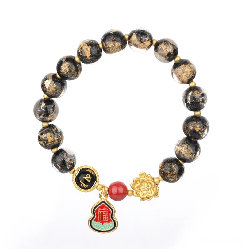 Complete Tibetan Om Mani Padme Hum Liuli glass bracelet with spotted beads, gold lotus charm, red accent bead, and Fu enamel pendant