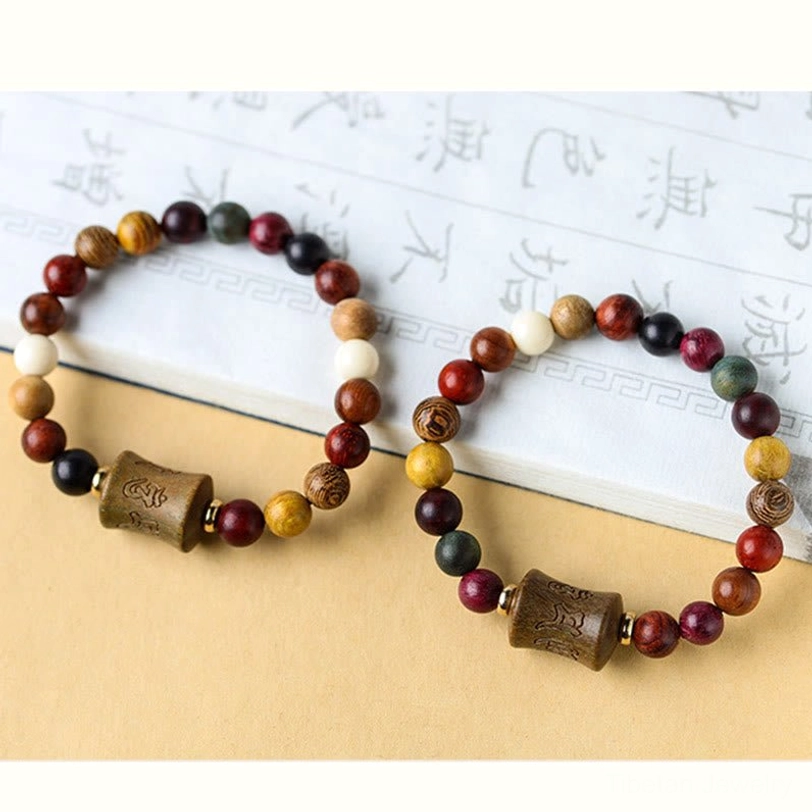 Tibetan Om Mani Padme Hum sandalwood bracelet with copper accents showing complete bracelet design and spiritual carving artistry