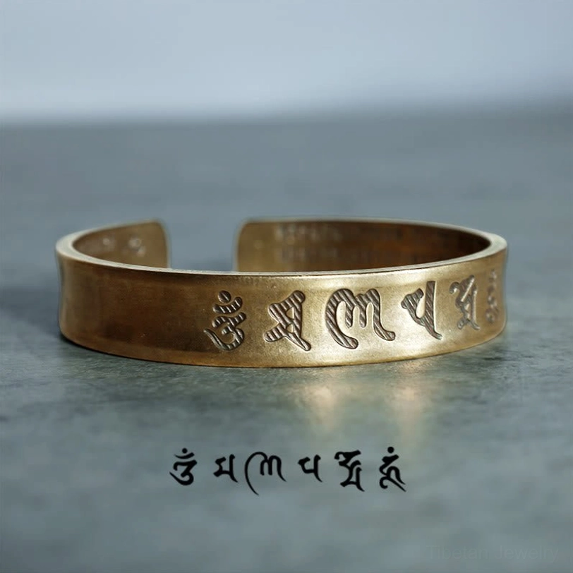 Antique bronze Tibetan six-word mantra cuff bracelet side view with script annotation