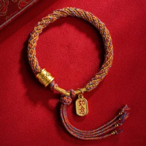 Handmade Tibetan Om Mani Padme Hum Ruyi multicolor braided bracelet with gold pendant charm flat lay