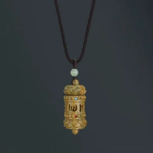 Tibetan green sandalwood Om Mani Padme Hum necklace pendant with Sanskrit carving, overhead studio view showing intricate mantra design