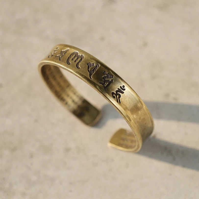 Open cuff Tibetan mantra bracelet with clearly engraved Tibetan script detail